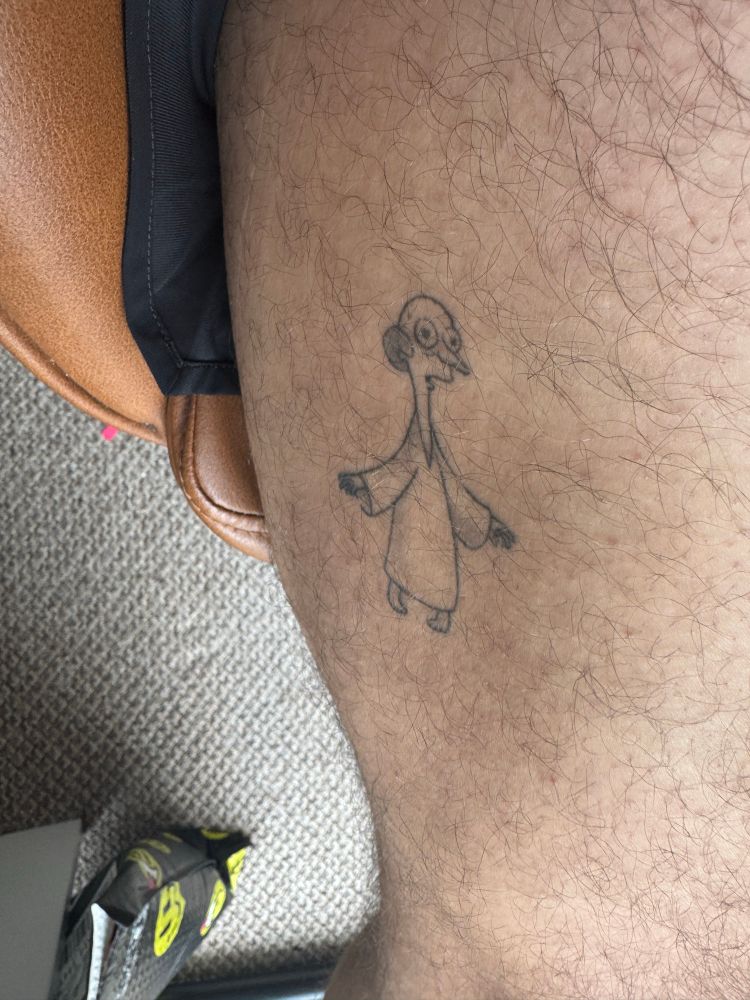 A Mr. Burns tattoo on a man’s thighs, he is in short shorts