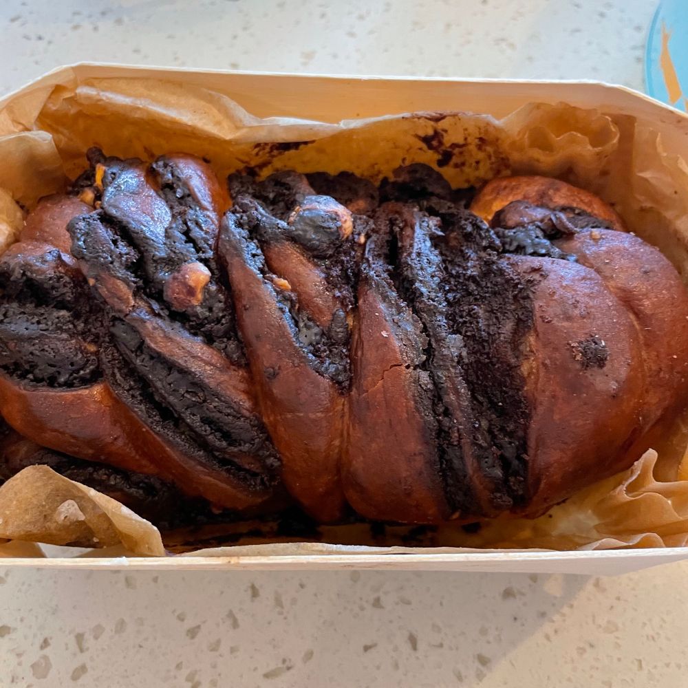 A small plaited chocolate and plain loaf shaped cake. 