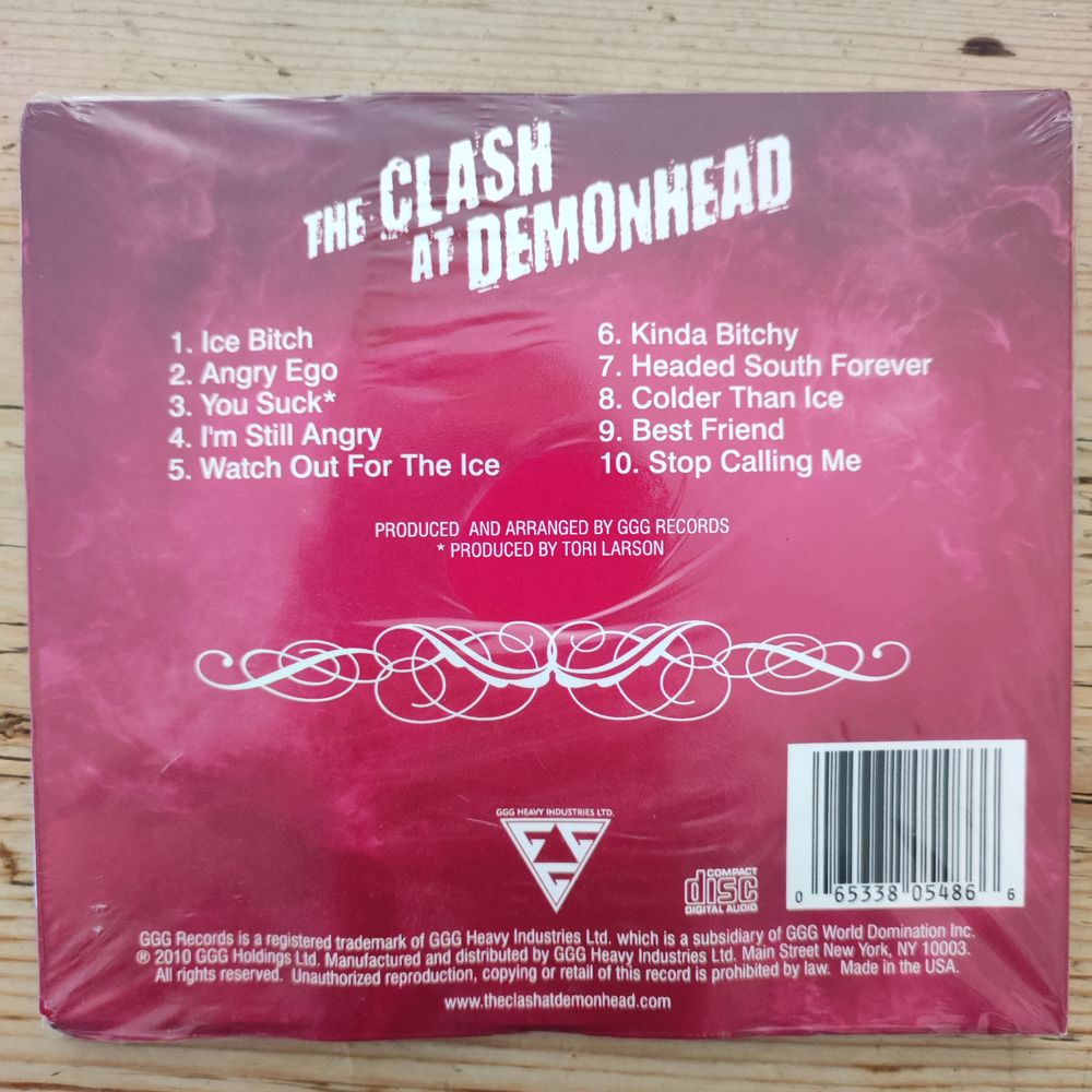 Complete CD back cover of The Clash at Demonhead, with song titles, (including "Ice Bitch", "You Suck" (produced by Tori Larson) and "Stop Calling Me") production credits and even the copyright smallprint at the bottom.