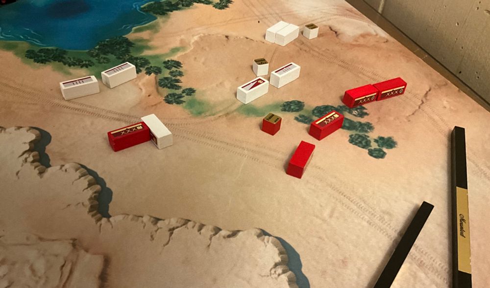 Pub battles unit blocks on a full color desert map from battletech. The mat has a lake and some mountains as blocking terrain to give some limits to movement and flanking.