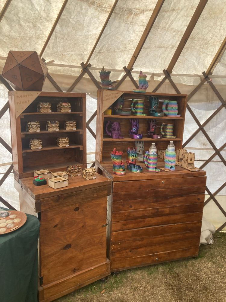 Shelves of dice boxes carved to look like mimics and colorful dice towers