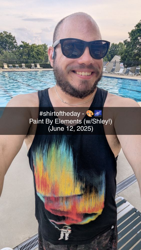 @mcswagger.bsky.social at the pool wearing a black tanktop featuring a space man painting the galaxy in the colors of teal, green, yellow, orange, and red. 