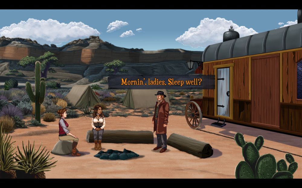 Harley and Nadine sit around the remains of a campfire in the desert during the day. Jake stands near them saying “Mornin’, ladies. Sleep well?”