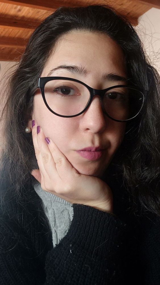 Woman with serious face wearing glasses, she is dominant and imposing. She is waiting for you to give her a gift. Her skin is white and her hair is black like her eyes and eyebrows. She wears glasses. She is a mistress.