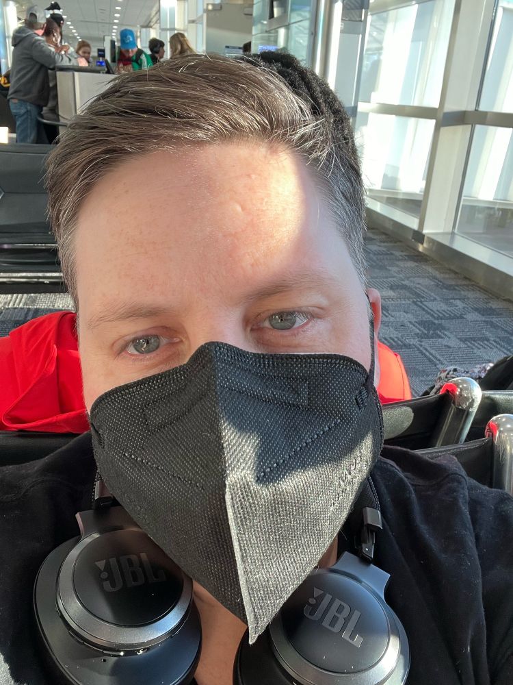 Sexy AF blue eyed butch wearing a mask 