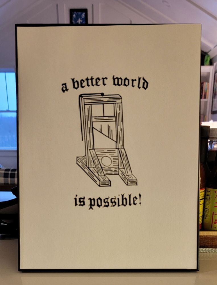 Black and White print of a guillotine. Text reads, "A better world is possible!" Print by Amy Mendelsohn @Coopsy.art 