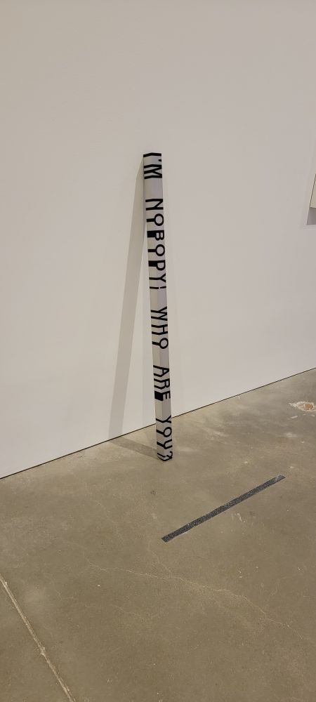 Roni Horn - Key and cue No 258. An aluminum pole with the words, "I'm nobody who are you?" dripping off the edges