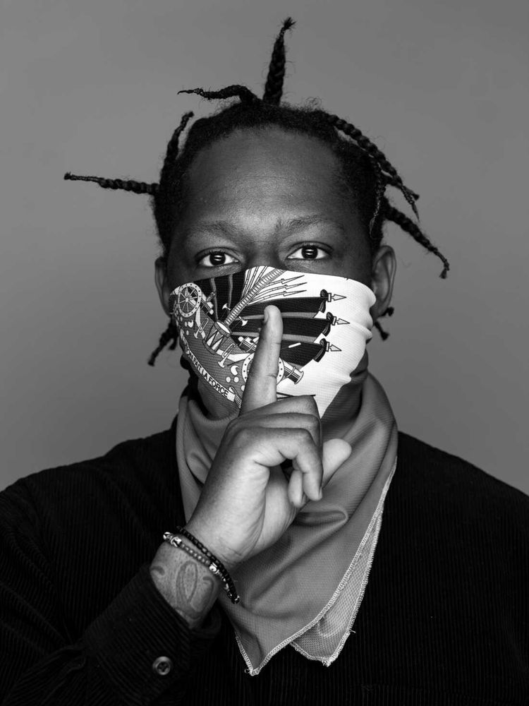Haitian American rapper and producer Mach-Hommy in a black and white photo. The artist covers bottom half of his face in every photo I’ve ever seen of him. 
