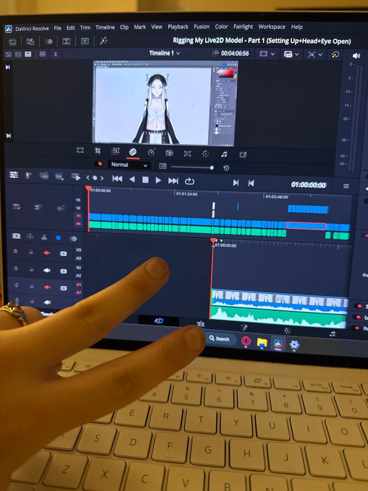 alex giving a peace sign in front of a partially edited video in editing software of live2d vtuber avatar rigging