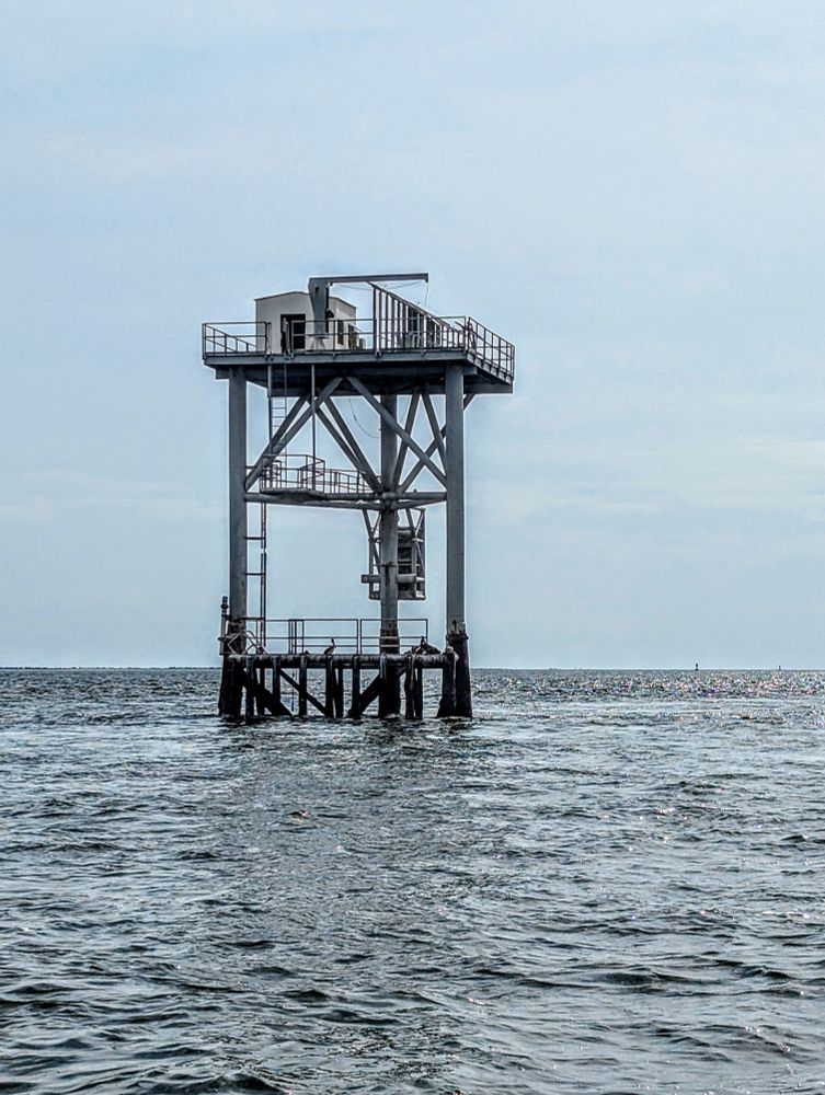 Some sort of industrial platform surrounded by open ocean.