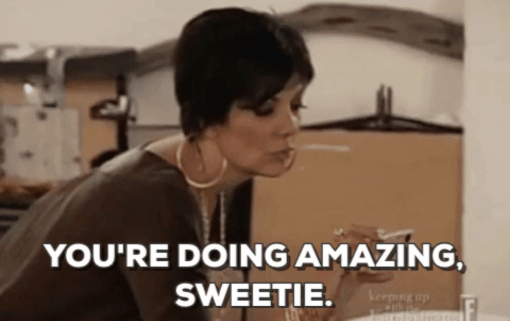 kris jenner leaned forward looking through a phone saying “you’re doing amazing, sweetie.”