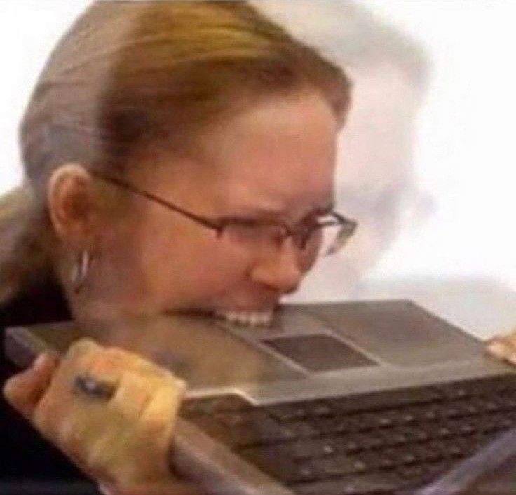 woman biting a laptop