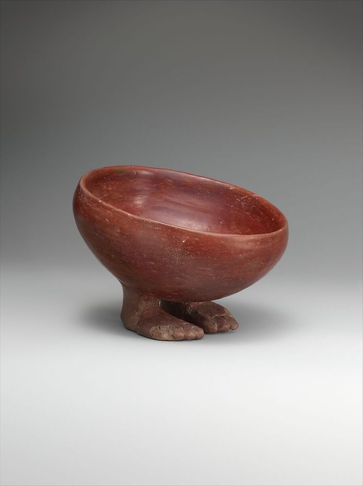 Little red earthenware bowl from the met. It has two little humanoid feet on the bottom and looks like he's standing shyly. Adorable.