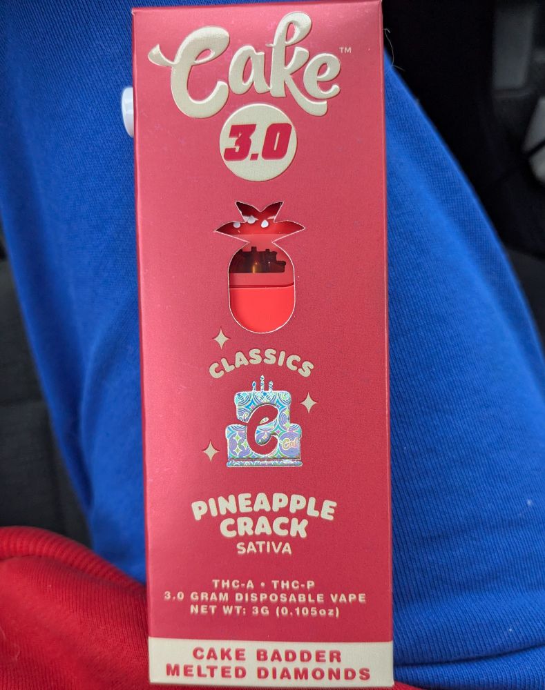 A 3gram disposable THC-A/p legal lab weed vape by the Cake brand, it's a sativa strain, apparently a classic, an it's flavor is Pineapple Crack. For some reason the box also reads "Cake Badder Melted Diamonds" but that is inexplicable to me. It costs $30 at the gas station and does in fact get u high. It's in an over engineered box with a little button on the side that you need to find a young child to figure out how to open it. Haha that part is a joke of course. My children with the nimble fingers are teenagers.