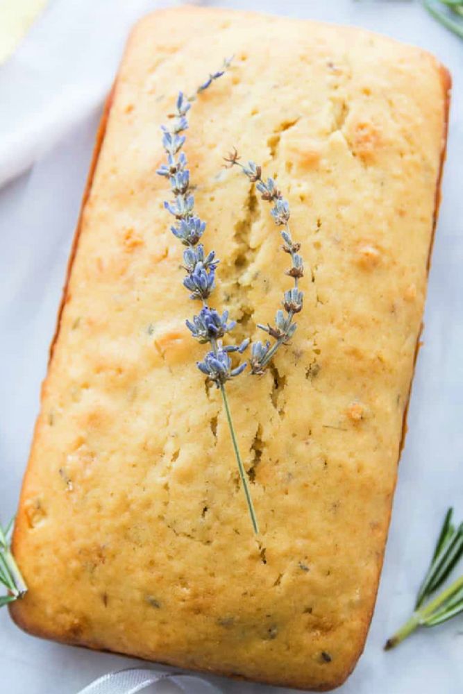 A photo that shows a loaf of lavender tea bread, a sweet lavender-vanilla baked good commonly served with tea.