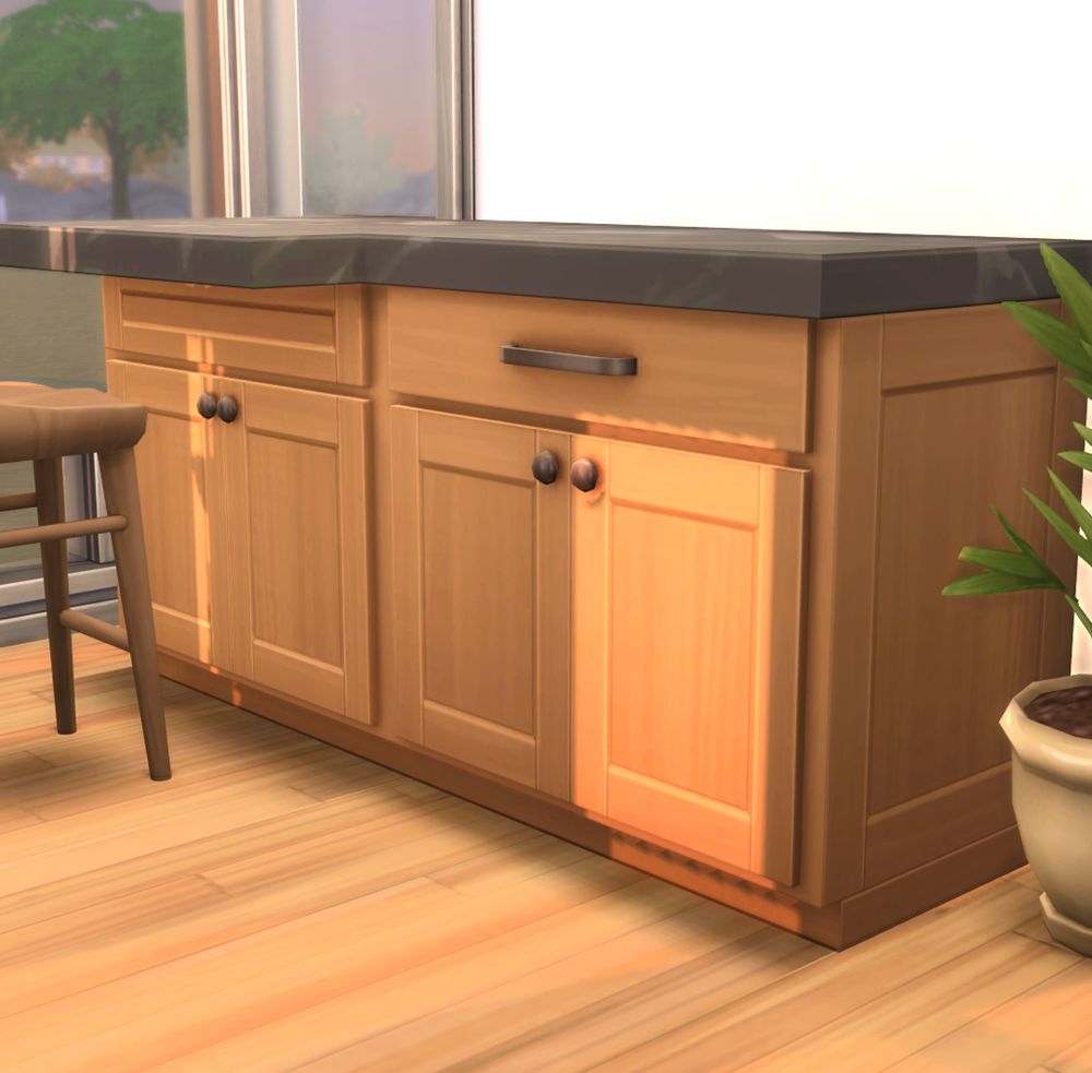 Modern kitchen cabinets in warm wood tone and dark counter top.