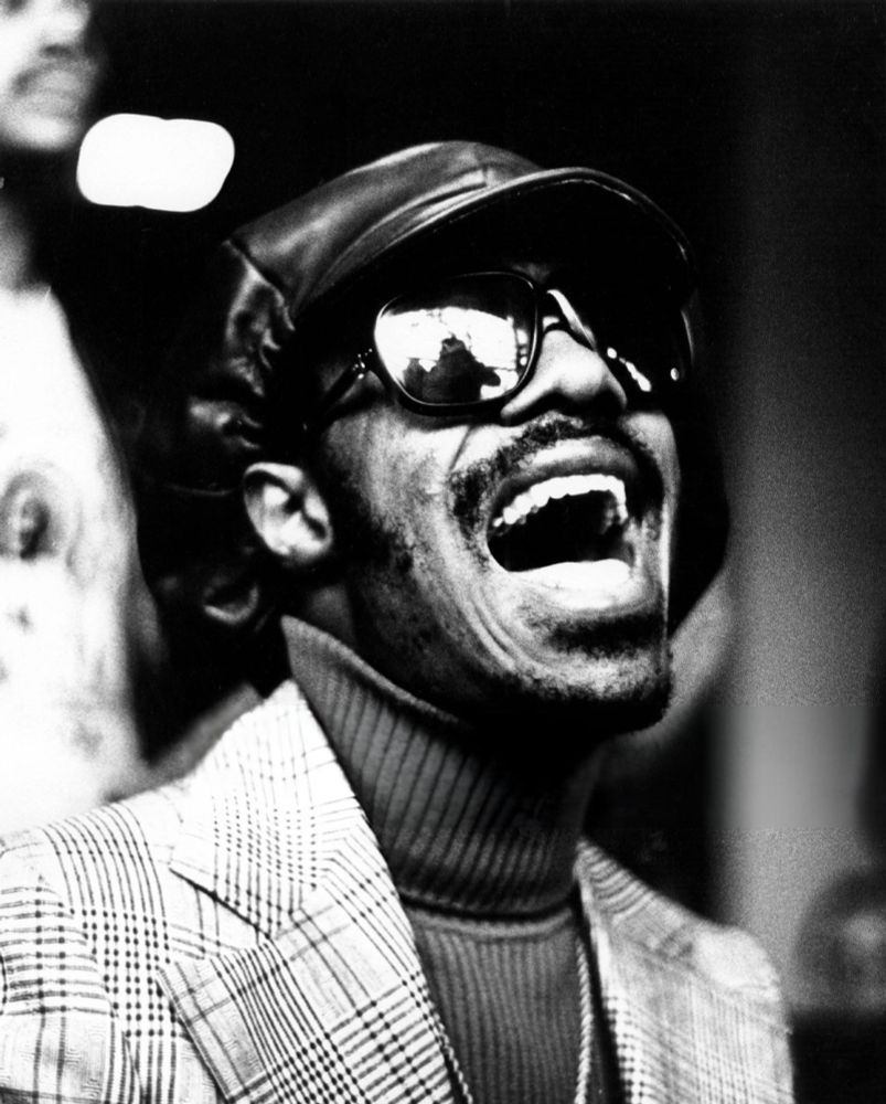 Similar photo, taken moments before or after the previous one. He appears to be singing.