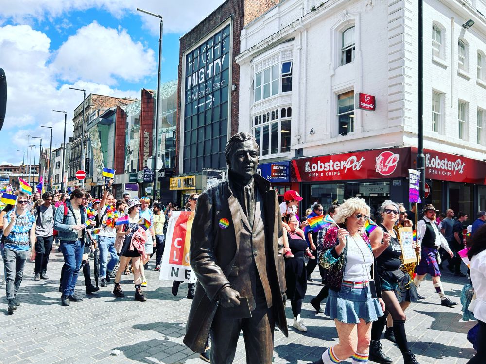 A colourful photo Brian Epstein being statuesque at Liverpool Pride 2023