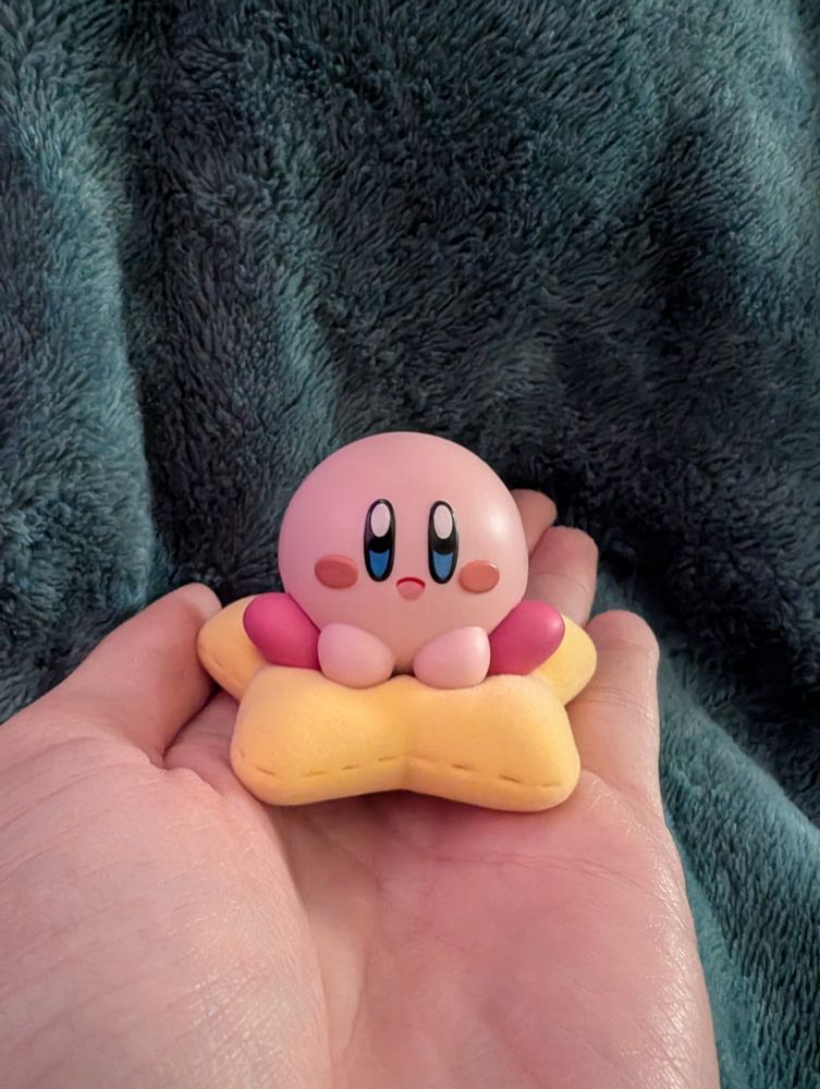 Figure of Kirby sitting on a star