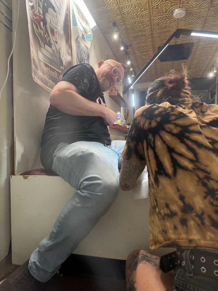Seth getting his Pickles tattoo in a tattoo truck. 
