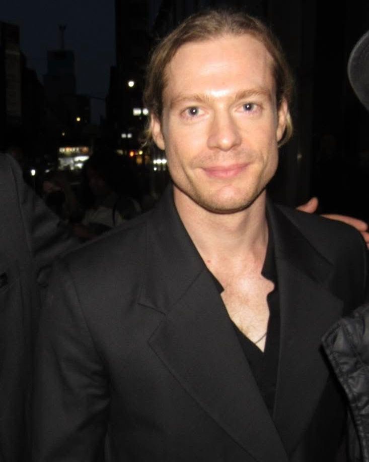 A recent photo of Sam Reid with long hair.