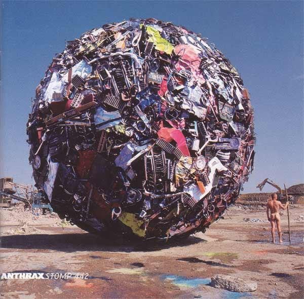 The cover of "Stomp 442" by Anthrax. It's like this big ball of trash and there's a tiny naked man next to it for scale. 