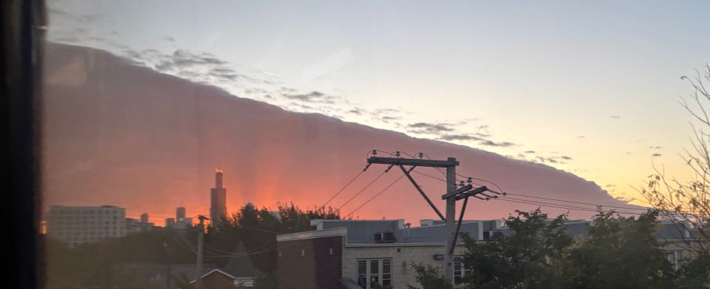 Panoramic pic of an ominously glowing Chicago skyline. 