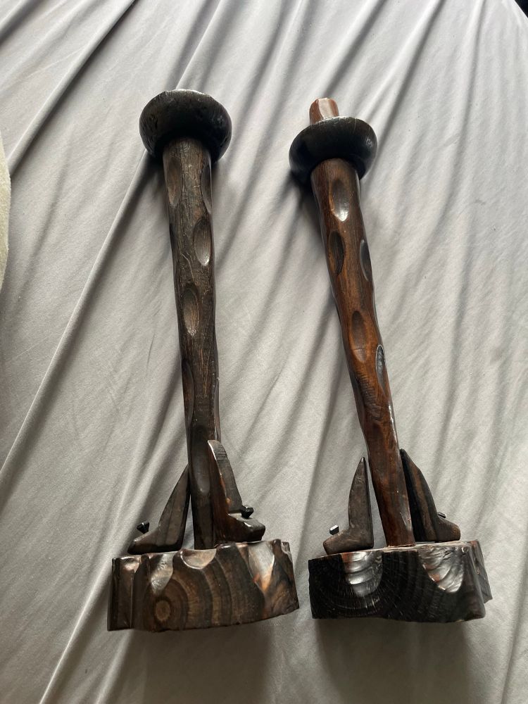 Two dark wood carved candlesticks 