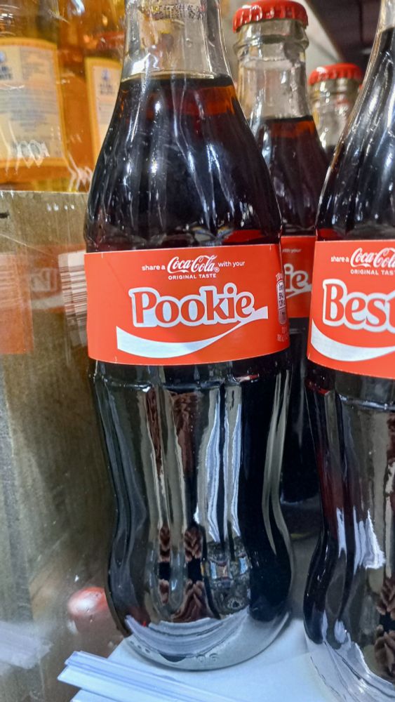 a picture of a small glass bottle coca-cola with the word "Pookie" on it's label.