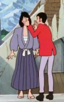 Screenshots of Lupin and Goe, Lupin is covering Goemon's mouth and making the shushing gesture with his own finger over his own mouth. Goemon looks surprised
