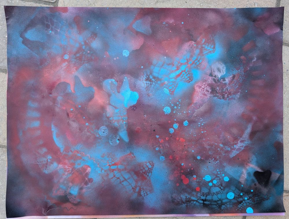 Abstract spray paint art in teal, red, and black
