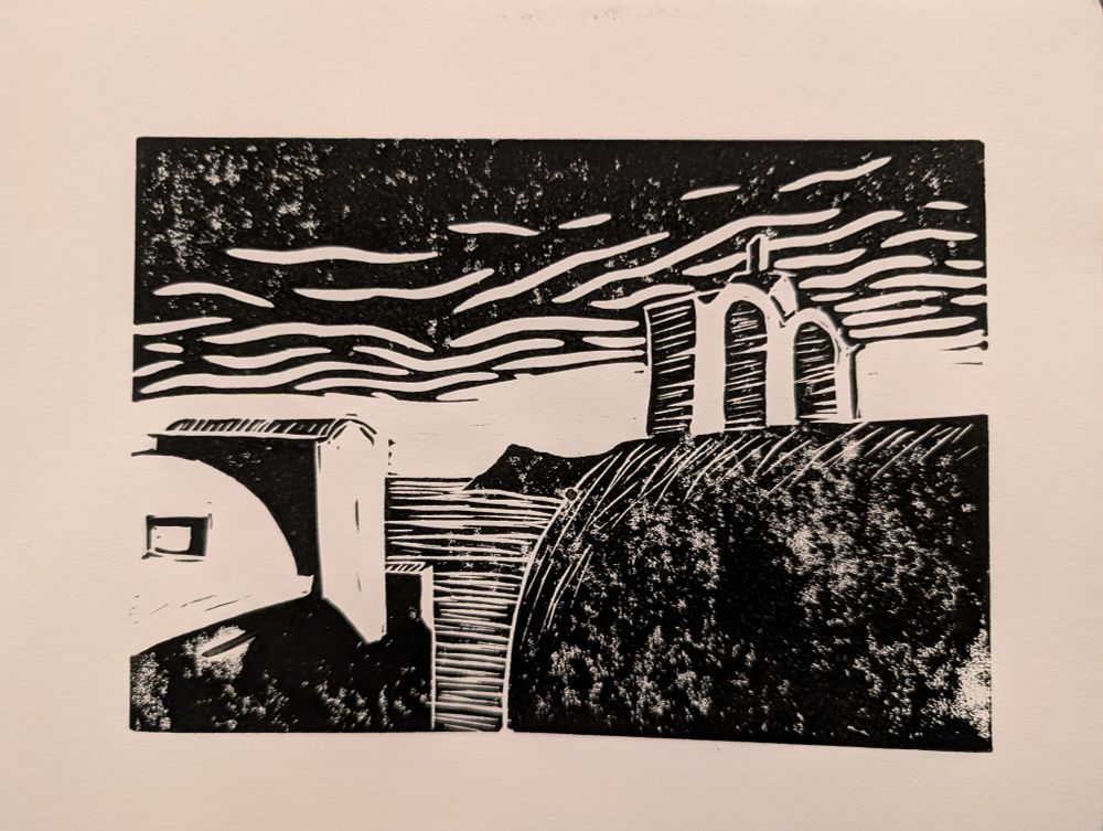 Lino print of a classic Santorini scene of a church with arched bell tower and cycladic buildings with the sea in the background 