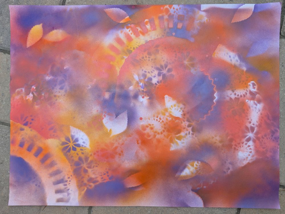 Abstract spray paint art in orange, lavender, and goldenrod 