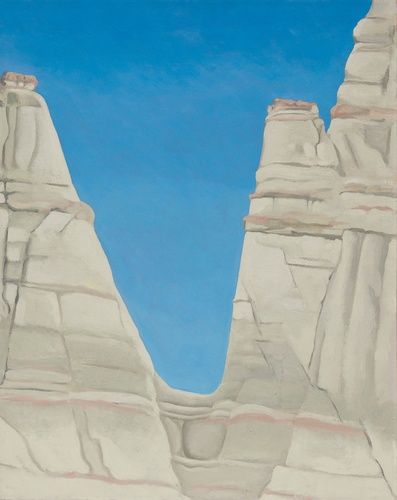 Georgia O’Keeffe could see the dramatic geological formation known as the White Place, or Plaza Blanca, from a window in her home near Abiquiu, New Mexico. Composed of white stone that provides a stark contrast to the colors of the surrounding terrain, the White Place was whittled and smoothed by water and wind over centuries into a striking formation resembling columns, cliffs, and spires. O’Keeffe painted it a number of times, and in The White Place in Sun, she selected a view that emphasizes a deep cleft in the formation. The V-shaped composition enabled her to focus on the interplay between the brilliant blue sky, the eerie white color, and horizontal striations of the carved rock.

Bequest of Paul and Gabriella Rosenbaum