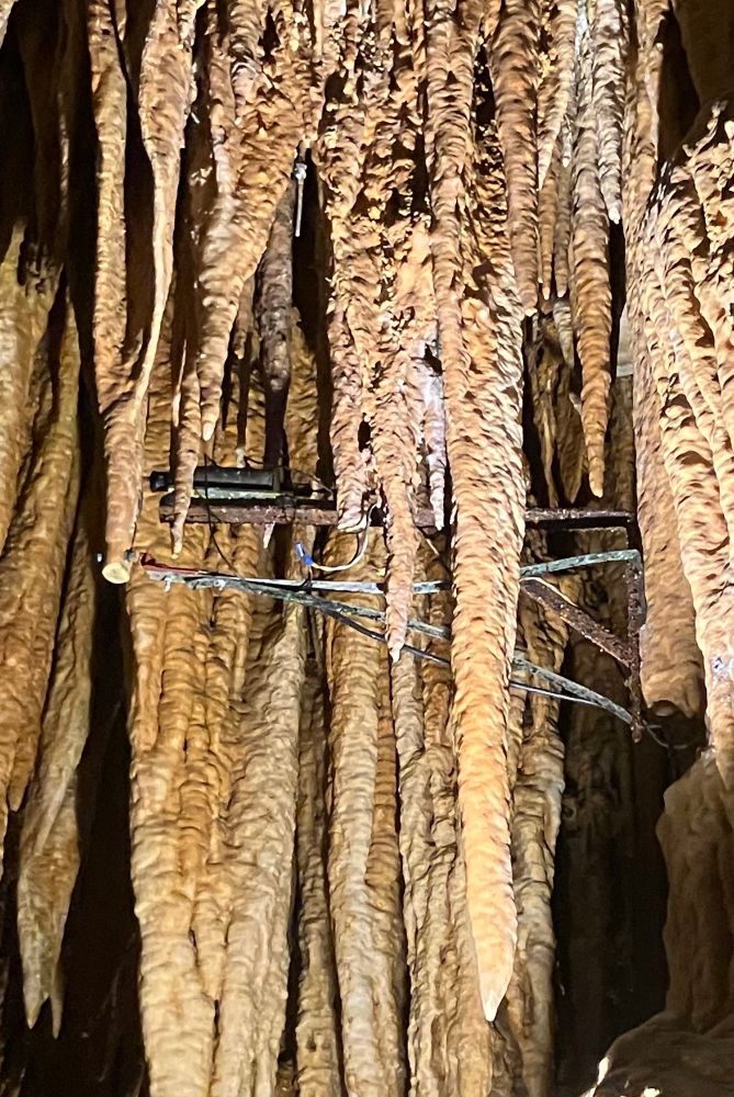 A close-up photograph of the stalactite hammer mechanism that is connected to the organ console in order to “play” the cave. The stalactites are apparently “tuned” regularly.