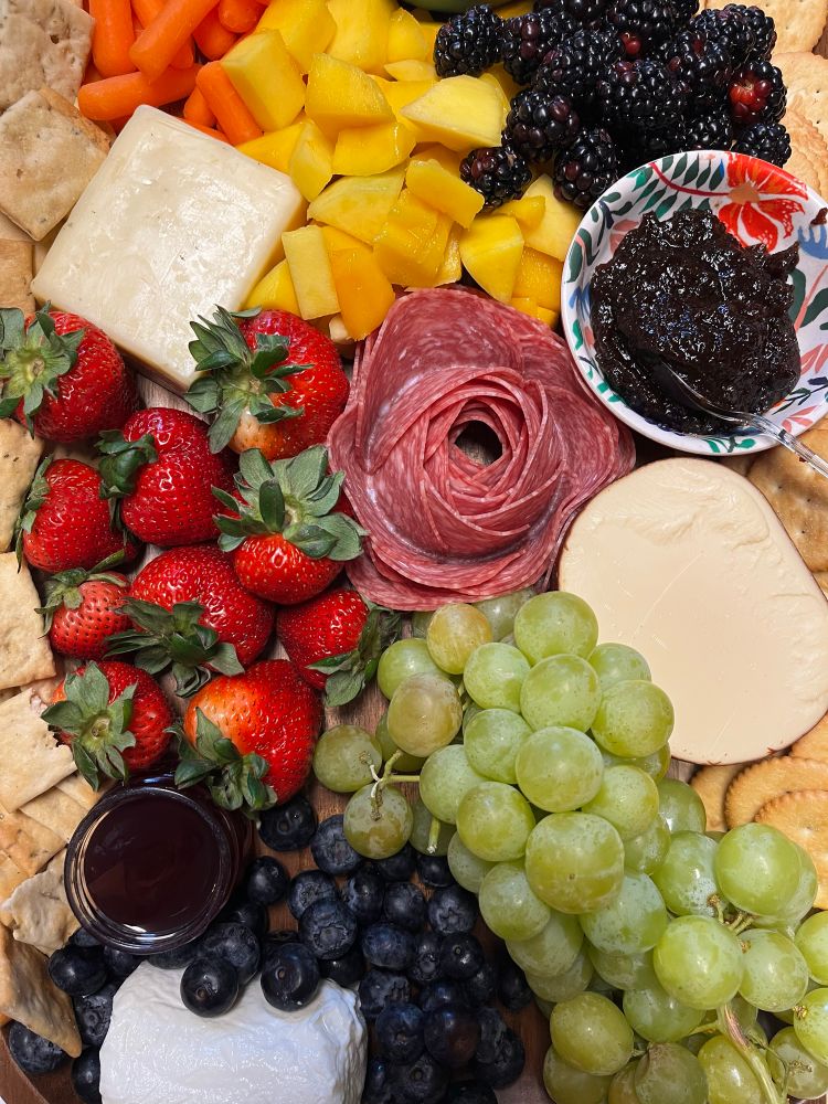 Closeup of a charcuterie board with three cheeses