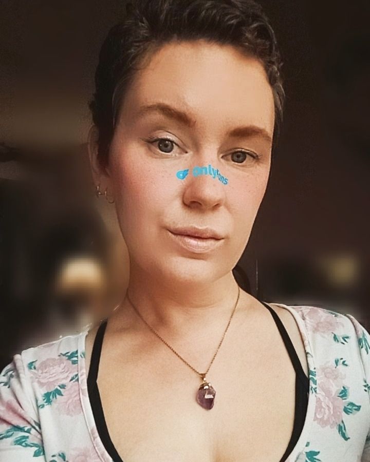 Liz Elytra, a white femme with kissable lips and a cute floral top is taking a selfie with a filter that says onlyfans across the bridge of my nose.