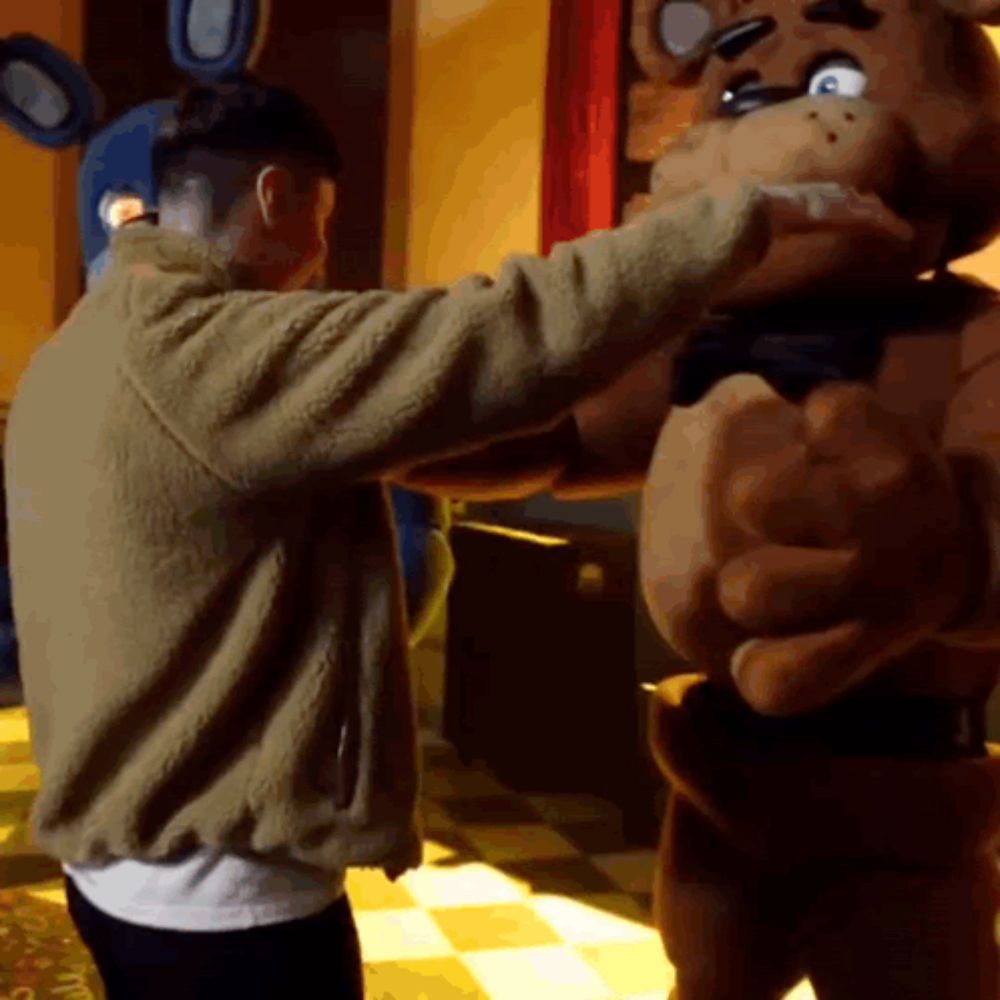 a man in a brown jacket is hugging a teddy bear costume