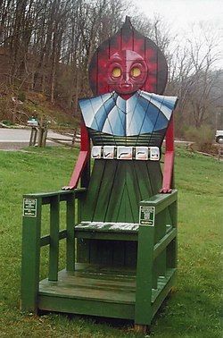 One of the outdoor Flatwoods Monster chairs you can find around Braxton County. It's a large, green chair with the Flatwoods Monster as the headrest. 