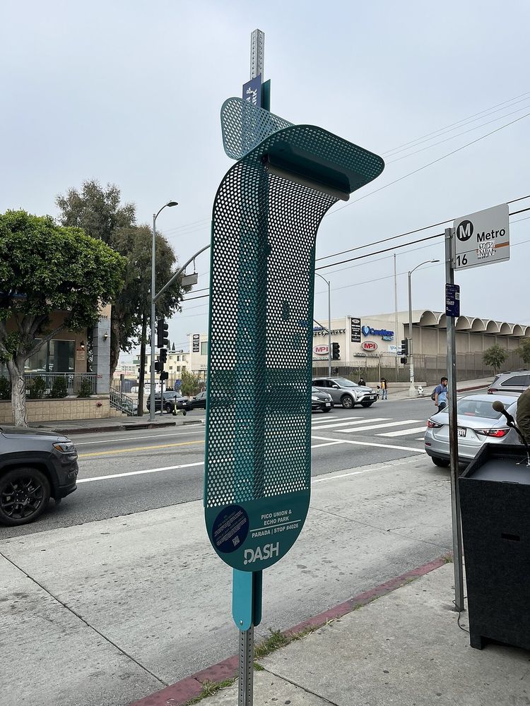 Photo of the 'la sombrita' bus stop sunshade from LA, unable to shade a single person from the sun at any time of day.
