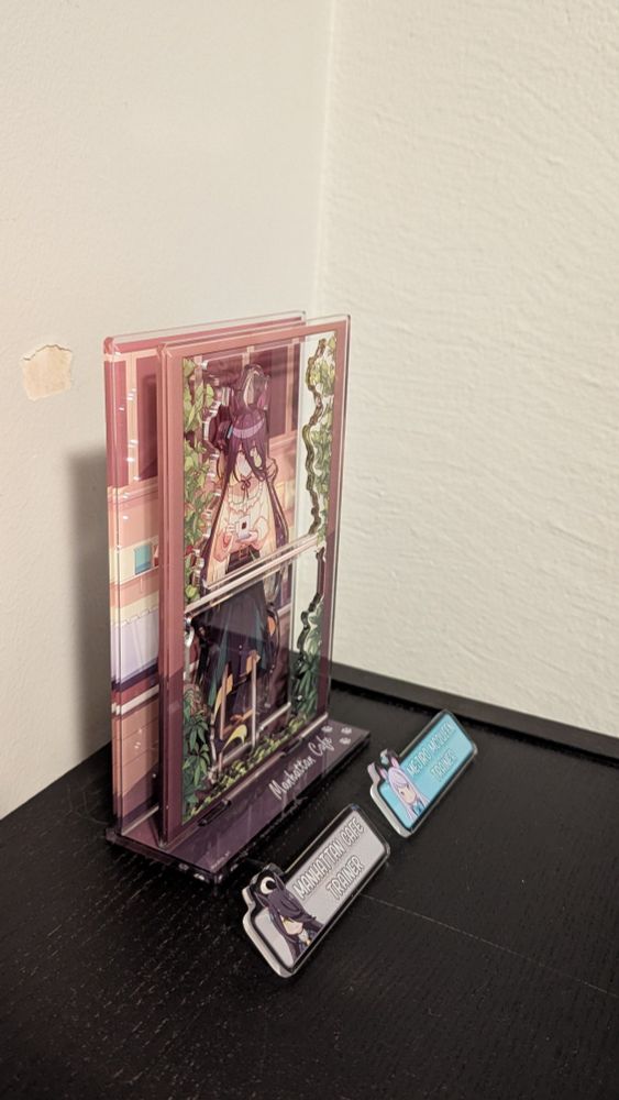 Two uma musume pins and a Manhattan Cafe acrylic stand 