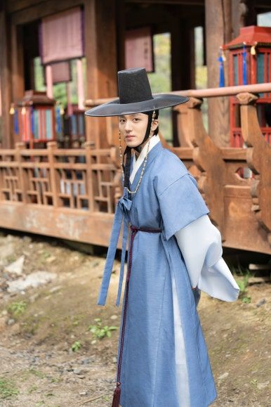 Chani (SF9) in his outfit from the drama 'The Scandal of Chunhwa'. He's stood just outside of a building.