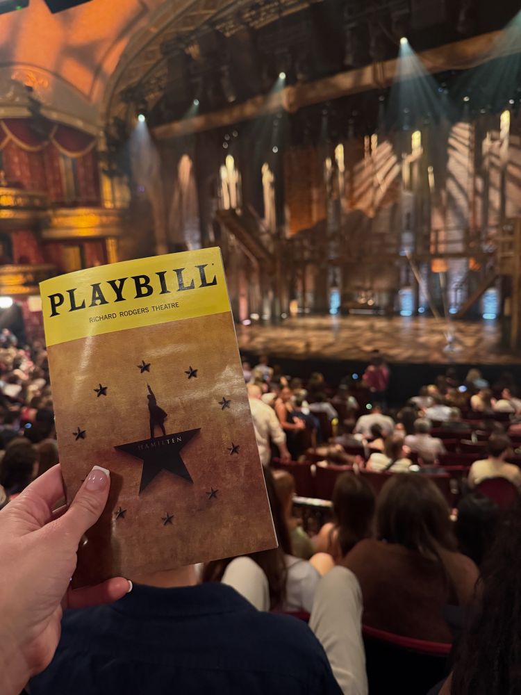 The Hamilton playbill in front of the stage.