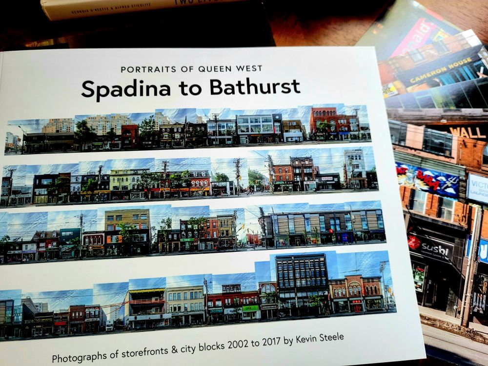 Book cover showing four streetscapes.
Beside the book, a set of 6 postcards showing various shop fronts.