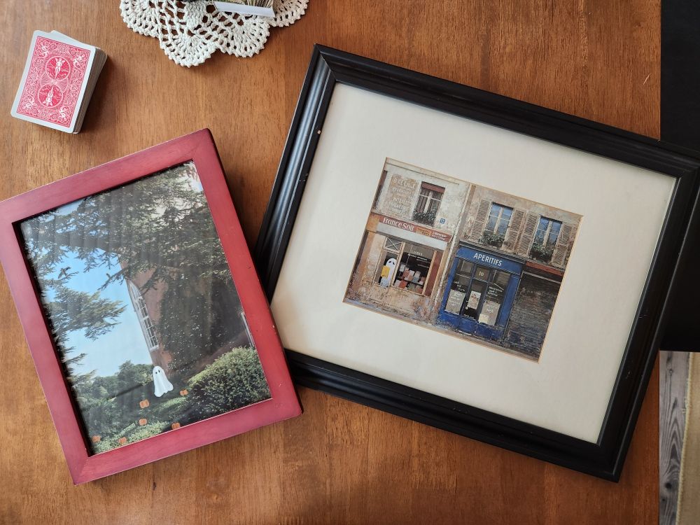 2 thrift store landscape paintings with spooktastic elements painted on by hand