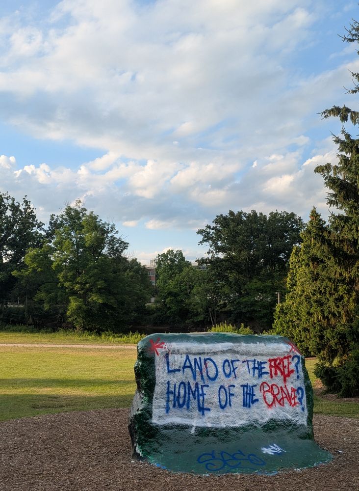 A big rock painted "land of the free? Home of the brave?"