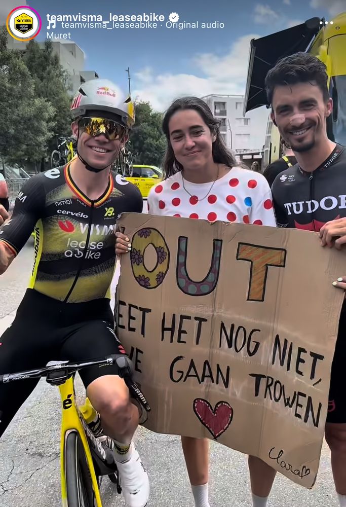 Wout, a supporter, and Julian with a sign that said “Wout you don’t know it yet but we’re getting married”