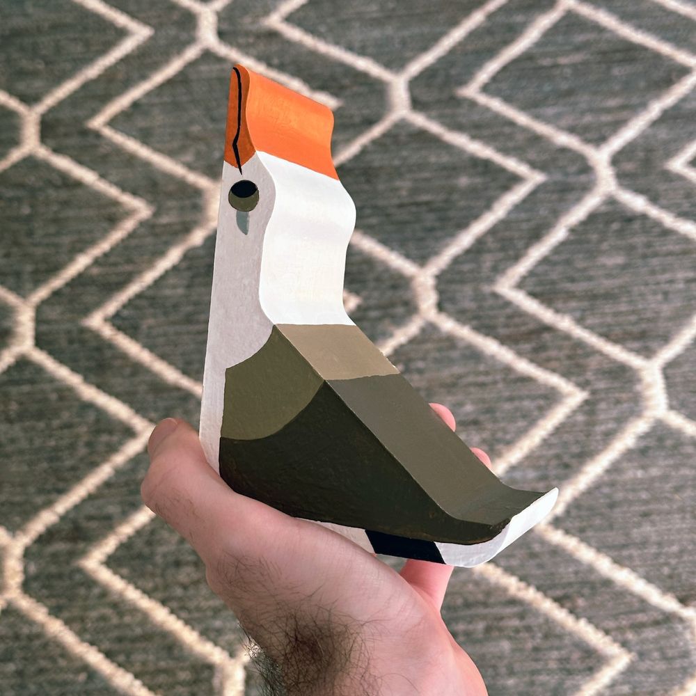 Holding up the bookend to for scale, it's hefty and made of cement! 