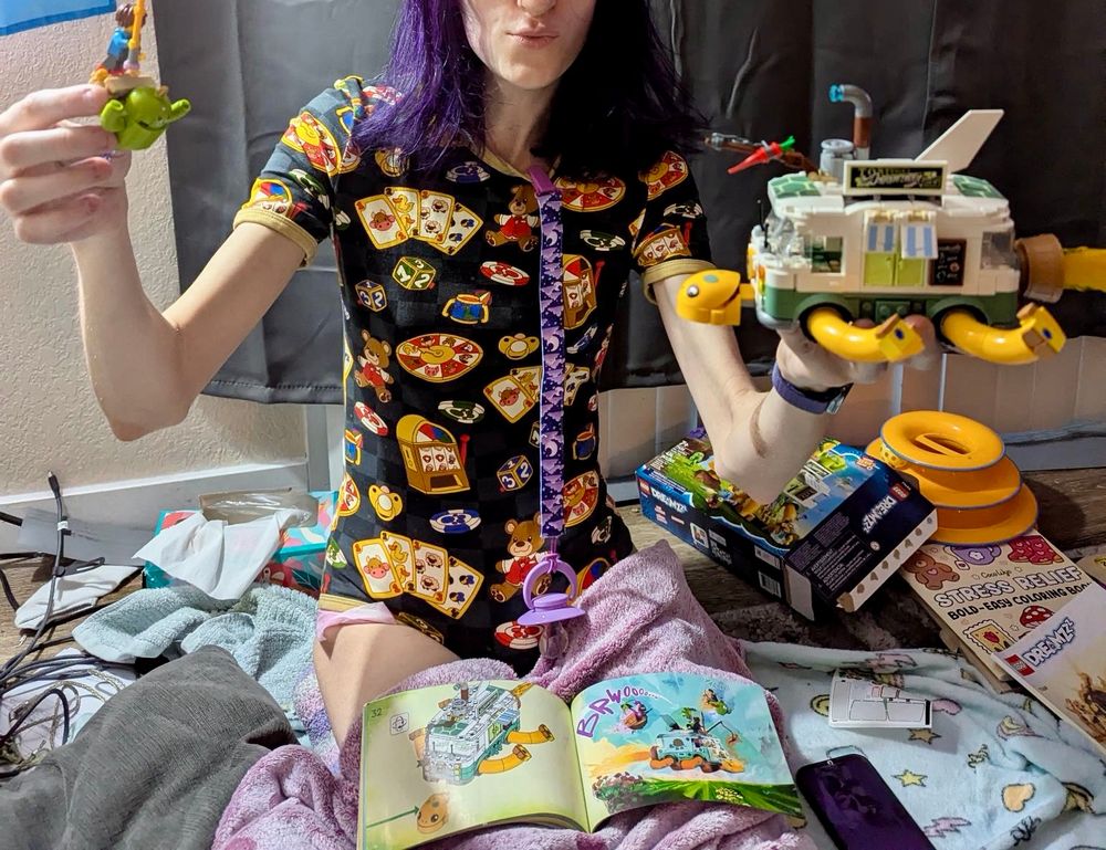 a young woman dressed as a big ol’ bab having some fun with Legos