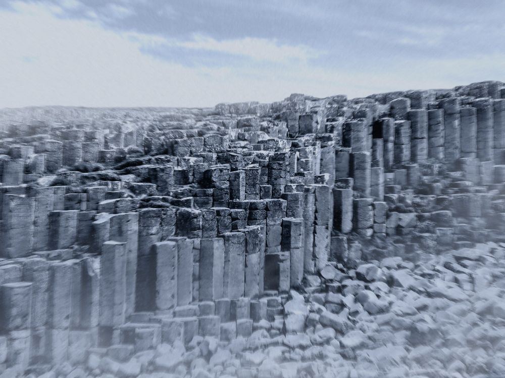 An image of columnar basalt. It’s had the contrast increased to show the texture of the stone better, and has been desaturated to give it more visual impact.